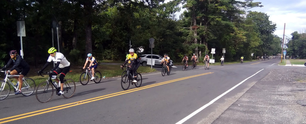 Bicyclists passing by approaching intersection.